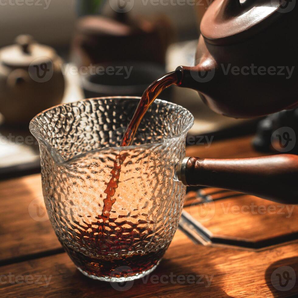 Experience elegant tea pouring with stunning textured glassware that enhances the moment photo