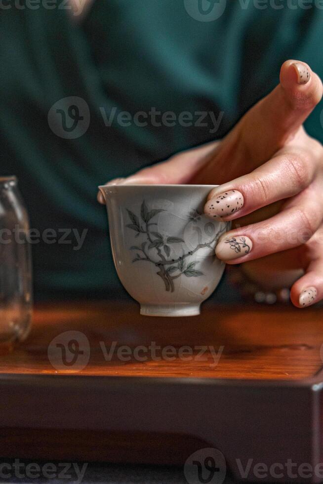 A beautifully Elegant Teacup with an Intricate Design, sitting gracefully in a Calm Setting photo