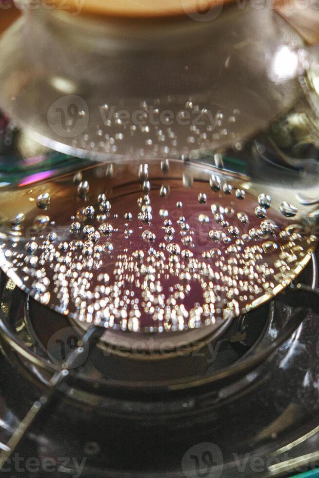 A CloseUp View of Bubbling Water on a Stove Capturing the Dynamic Movement of Liquid photo