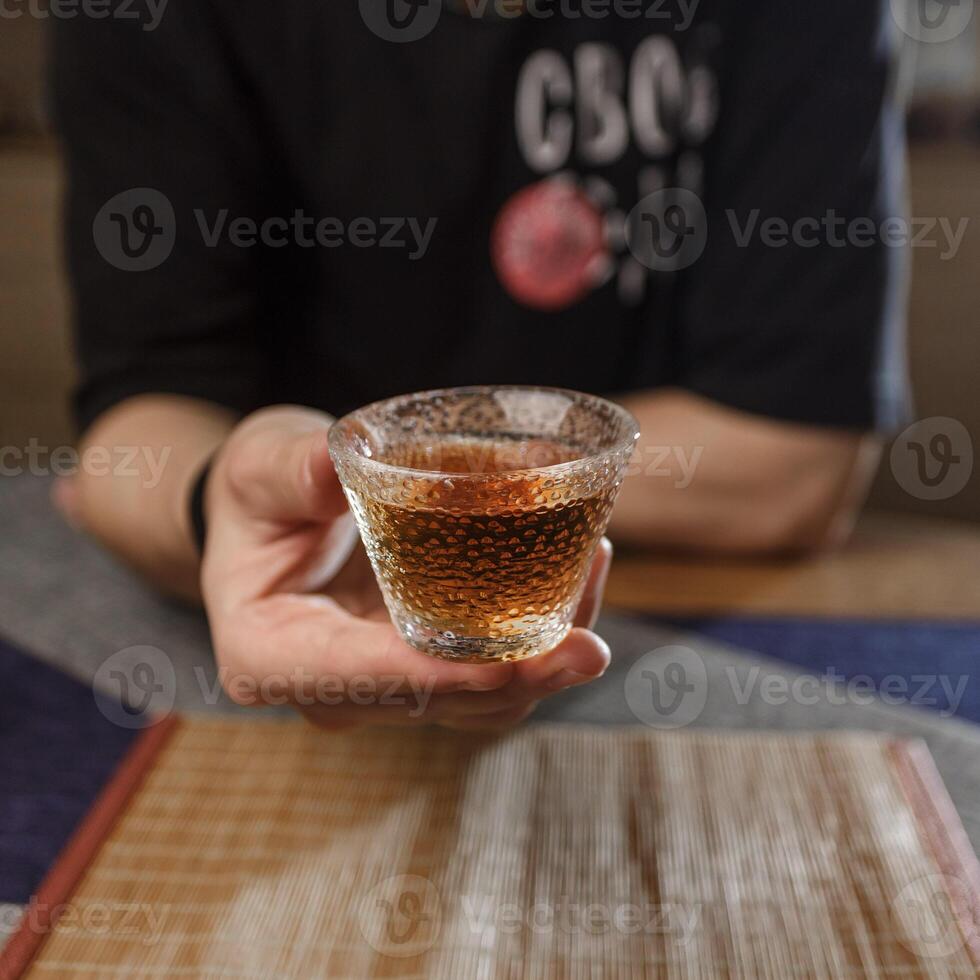 Enjoying a Refreshing Beverage in Hand While Surrounded by a Cozy and Inviting Setting photo