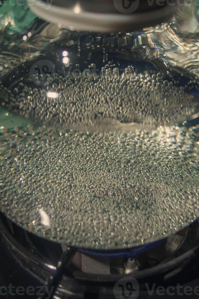 A CloseUp View of Bubbling Water Under a Glass Lid, Capturing the Intricacies of the Scene photo