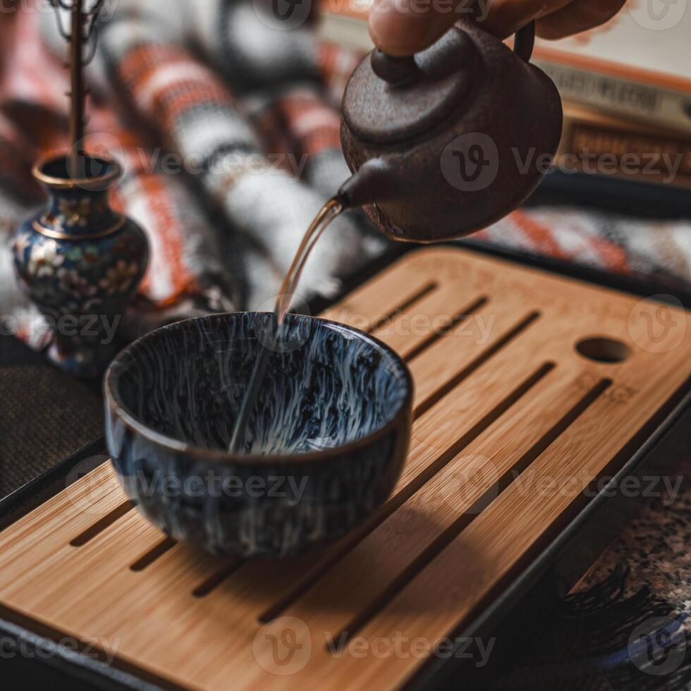 An Elegant and Serene Tea Ceremony Featuring a Beautiful Pot and a Unique Bowl for Brewing photo