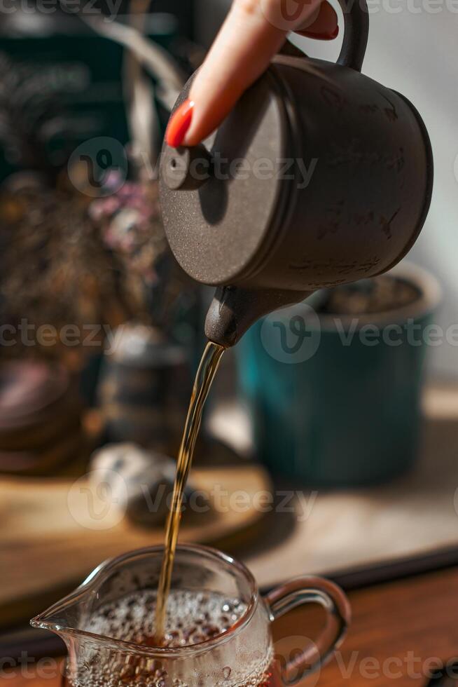Pouring Tea From a Traditional Kettle Creates an Inviting and Cozy Atmosphere to Enjoy photo