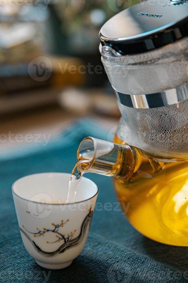 Delight in the Elegant Tea Brewing Process, Featuring a Traditional Teapot and a Fine Cup photo