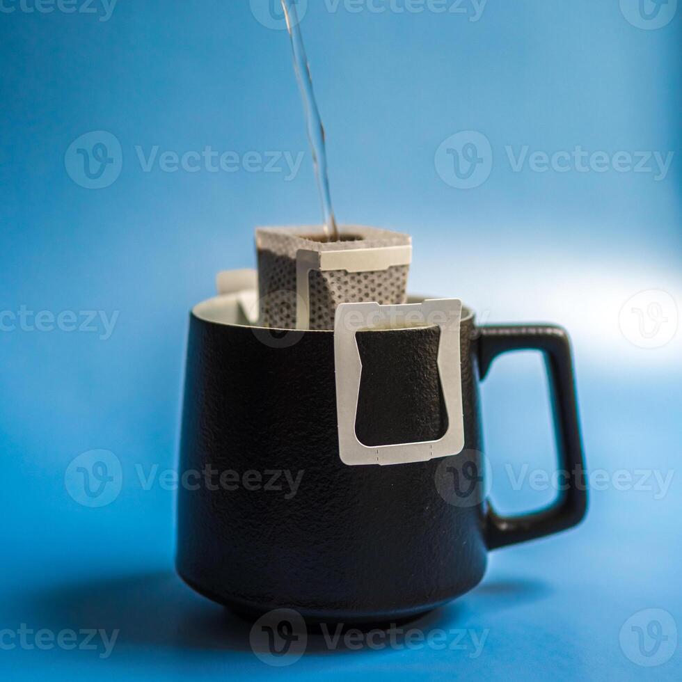 Brewing a Delicate Cup of Tea in a Stylish Black Mug Equipped with a Convenient Filter photo
