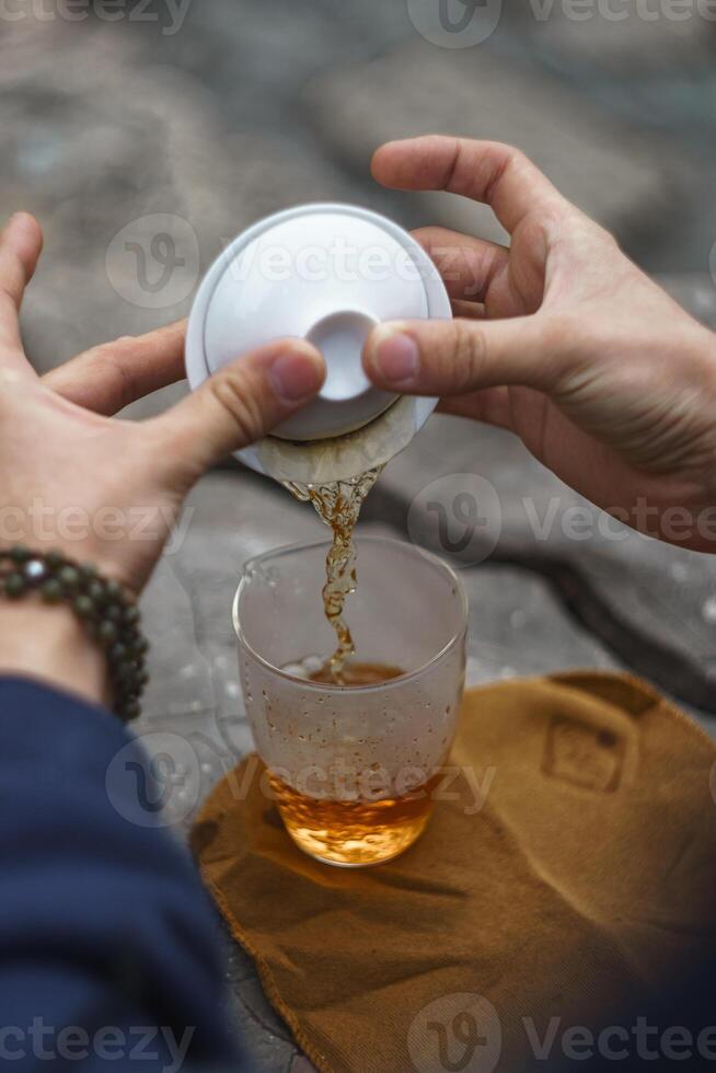 Enjoy a Refreshing Tea Moment Delicately Pouring a Sip of Natures Exquisite Brew photo