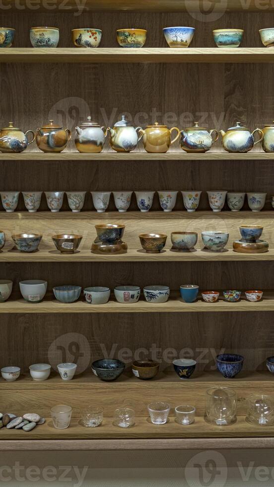 A Beautiful and Elegant Display Featuring Decorative Teapots and Teacups with Flair photo