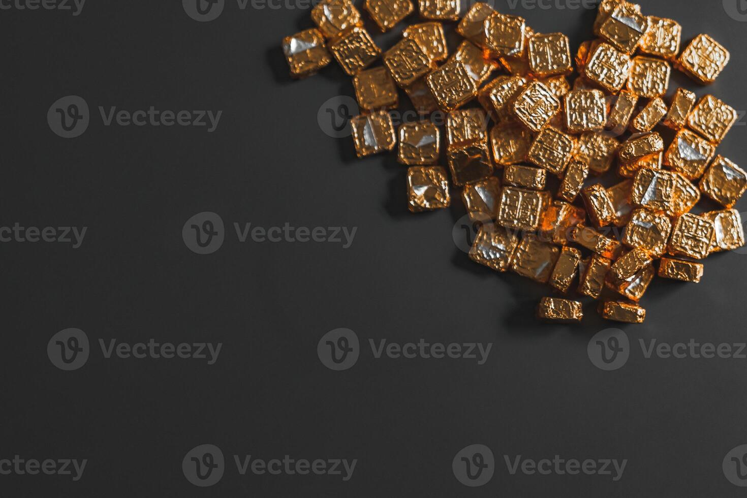 Beautiful Golden Caramel Candies beautifully arranged against a Dark Background surface photo