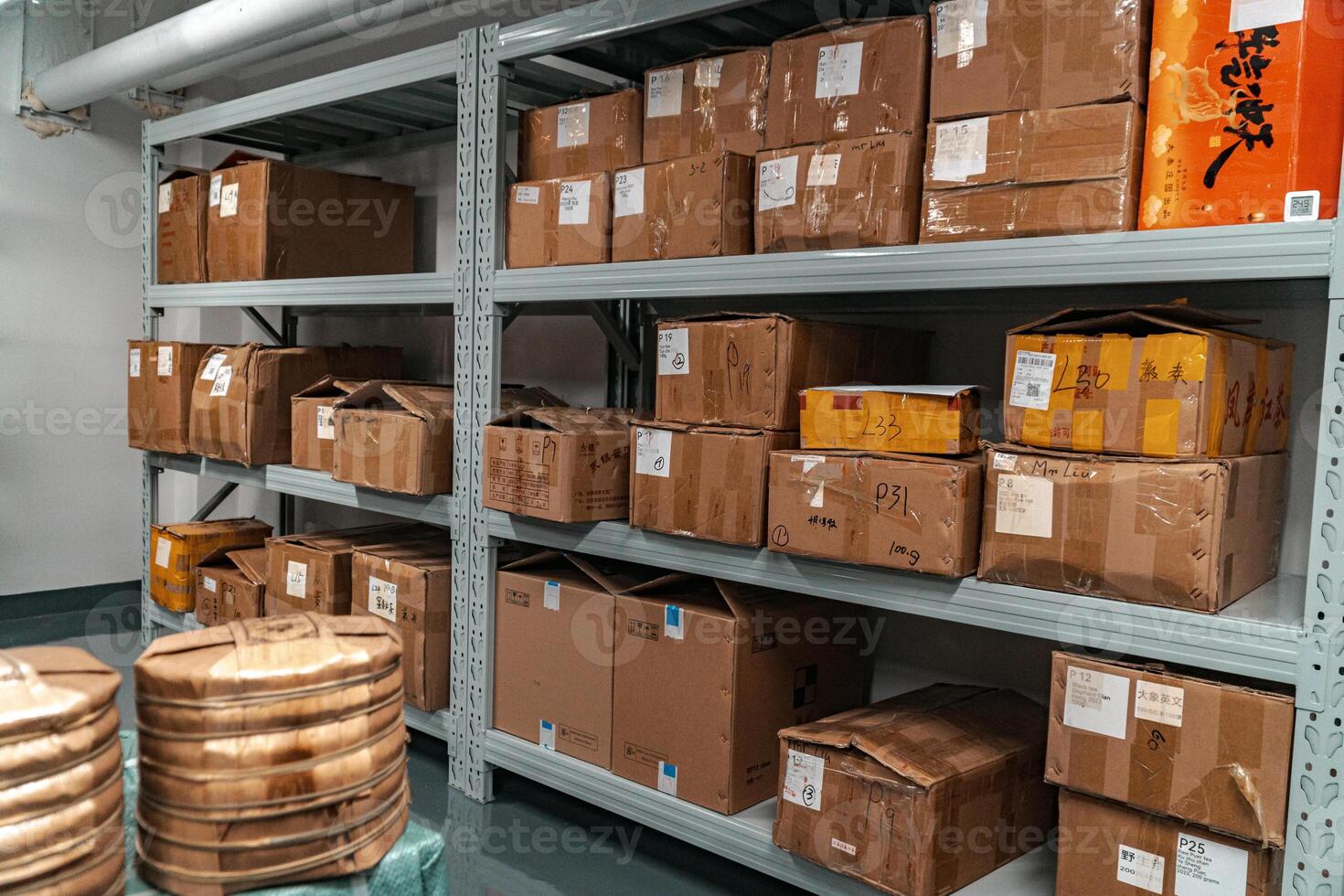 Organized storage in a warehouse is crucial, with packed boxes and labeled bins for efficiency photo