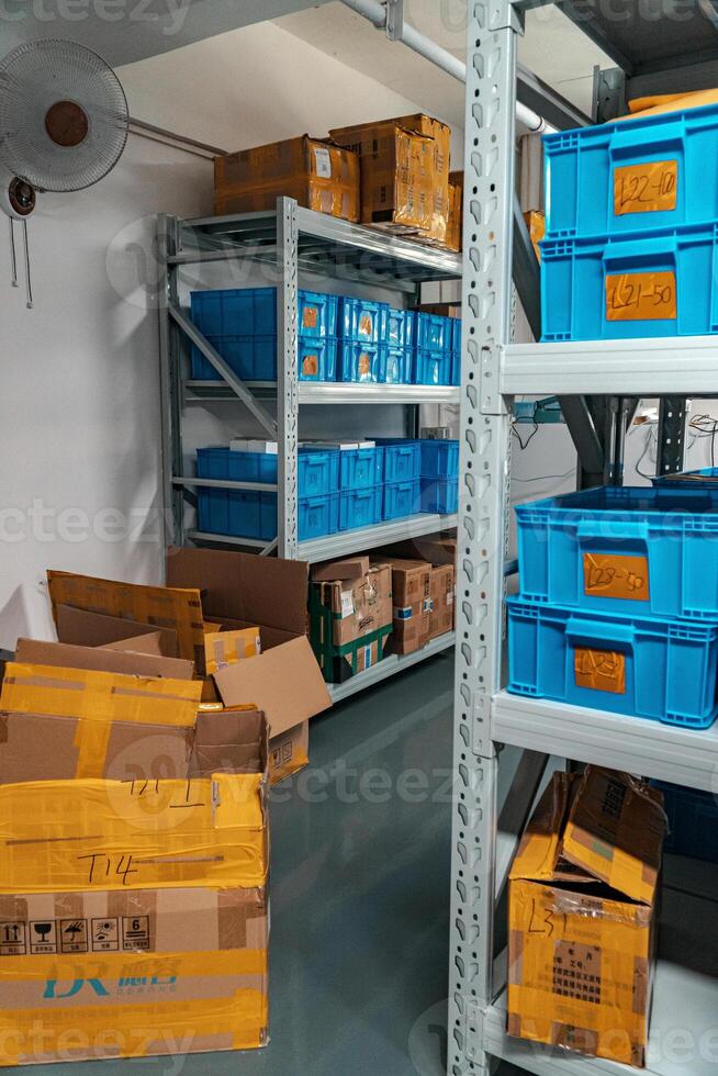An Organized Storage Area featuring numerous Blue Plastic Bins for various items and materials photo