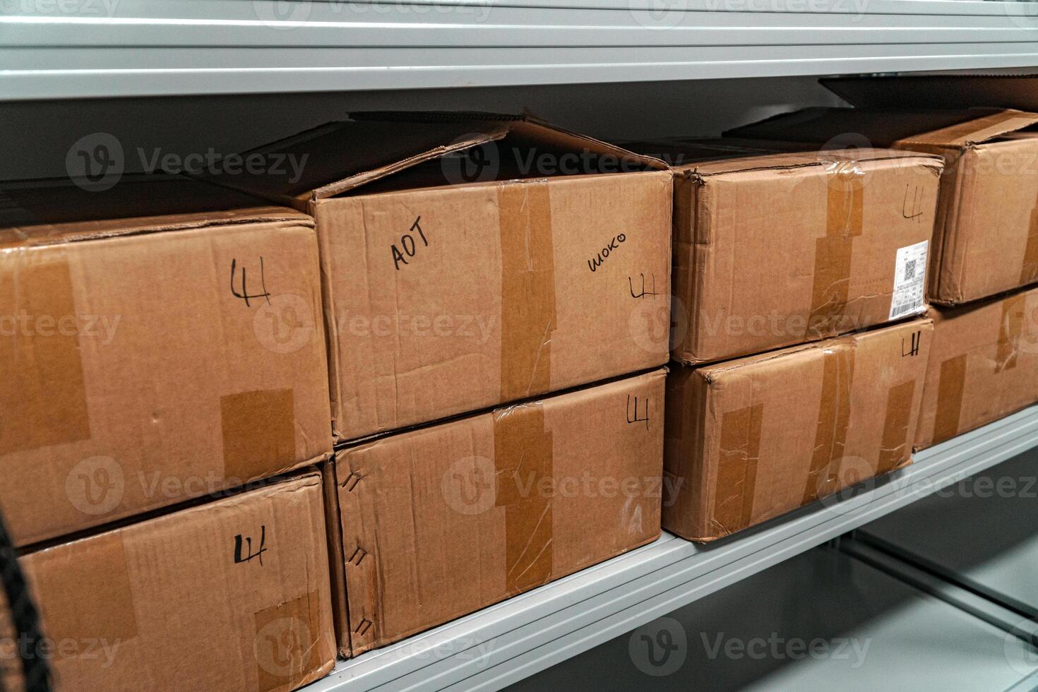 Organized and Efficient Storage of Various Cardboard Boxes on Neatly Arranged Shelves photo
