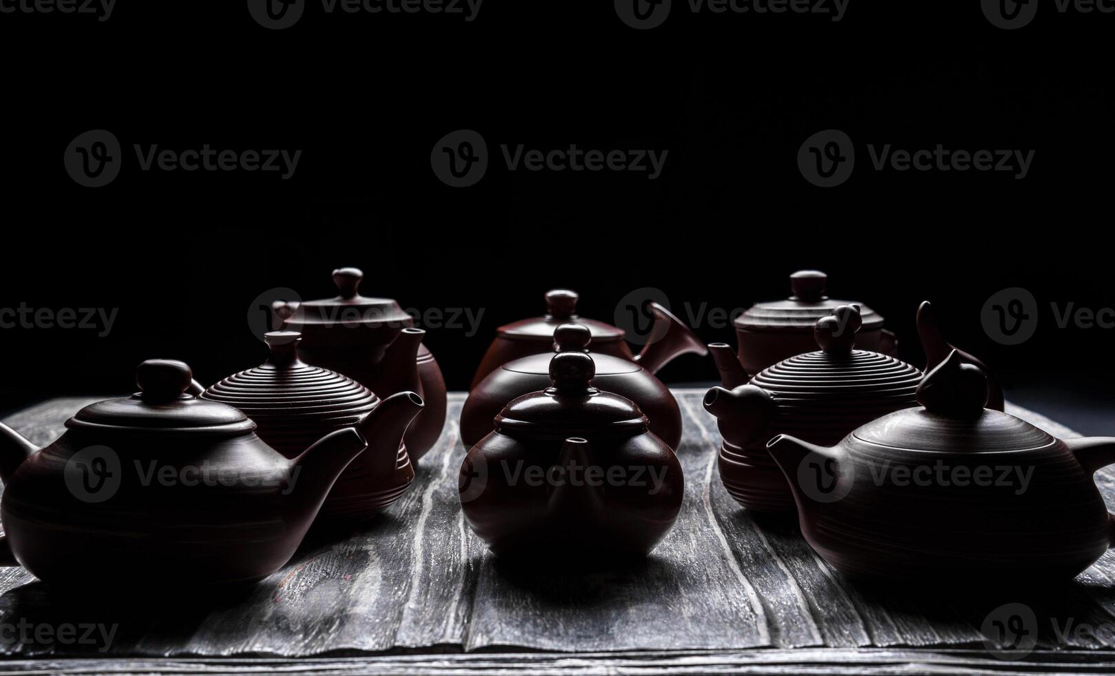 An Artistic and Captivating Display of Traditional Teapots Presented in Low Light Conditions photo