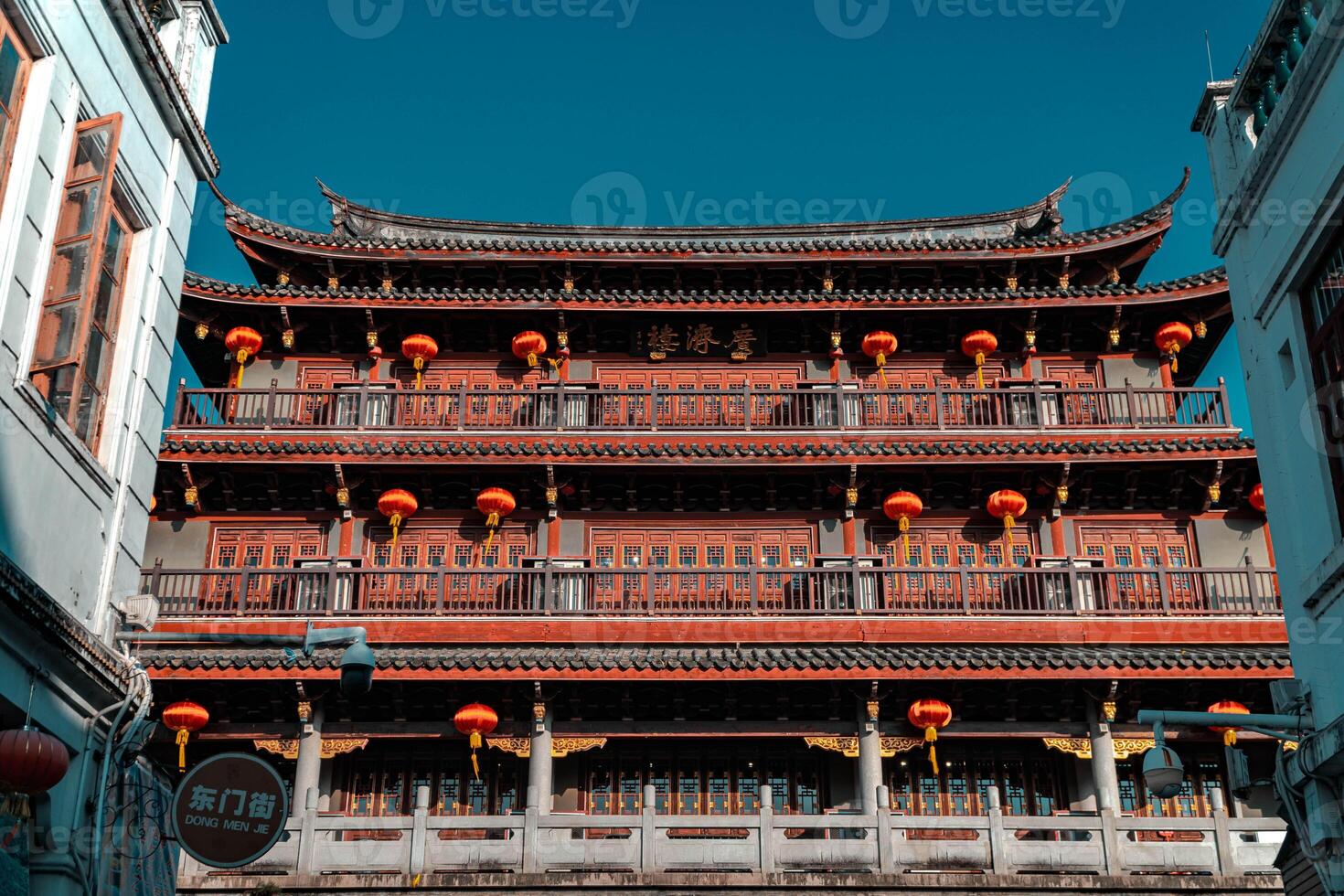 Traditional Chinese architecture against a clear blue sky showcases its grandeur photo