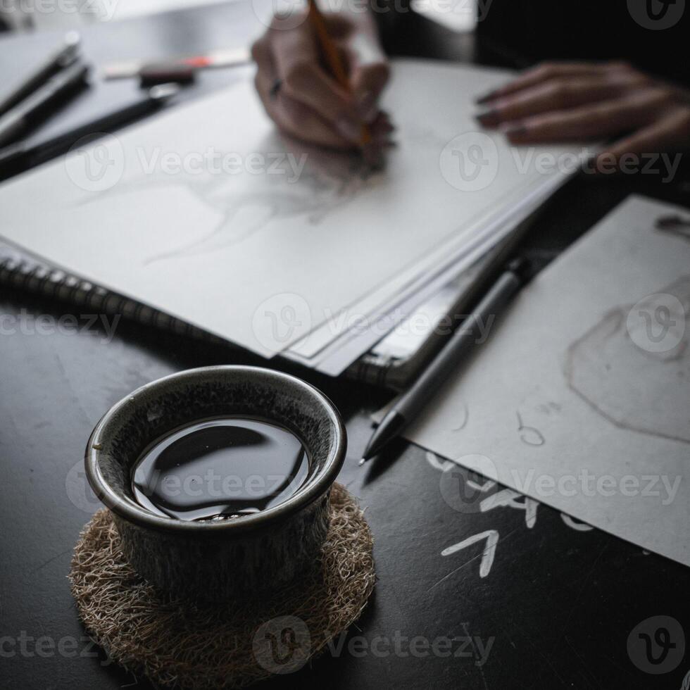 A Creative Workspace That Features Drawing, Imaginative Endeavors, and Enjoying Tea photo