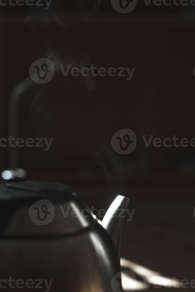 An Elegant Teapot with Steam Rising in Soft Ambient Lighting, Creating a Cozy Atmosphere photo