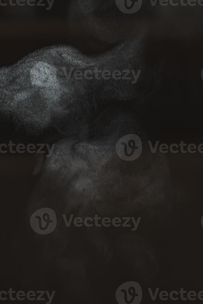 Exploring Abstract Smoke Patterns Created Within a Dark and Enigmatic Atmosphere photo