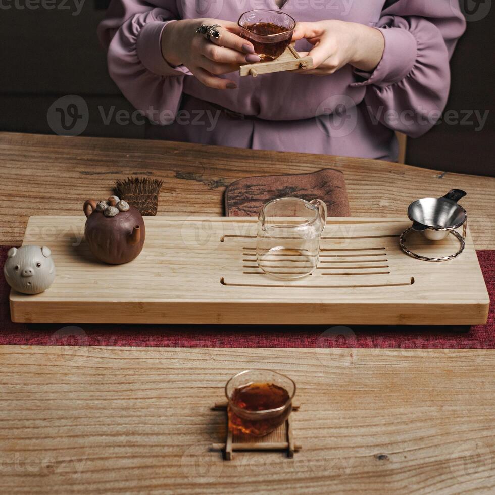 An Elegant Tea Ceremony Setup Featuring Both Glass and Ceramic Teaware for Enjoyment photo
