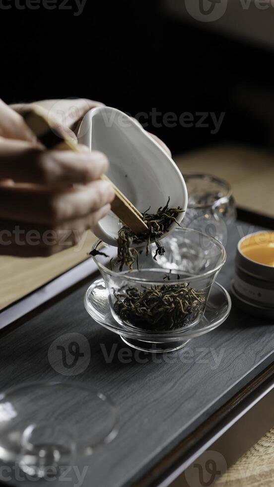 The preparation of tea using loose leaves and a dedicated tea set enhances the experience photo