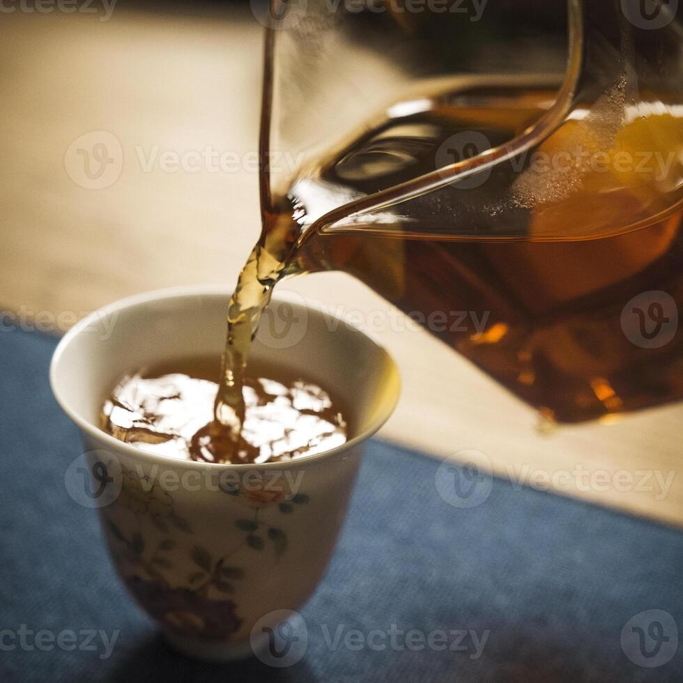 The Art of Tea Pouring into a Delicate and Elegant Cup, Emphasizing the Fine Details photo