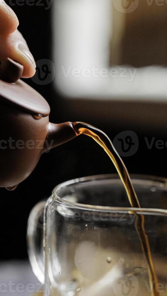 Artisan Tea Being Beautifully Poured from a Traditional Teapot with Careful Attention photo