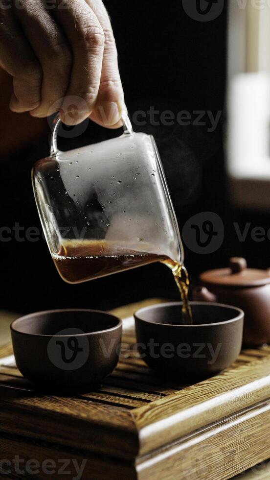 The Artful Tea Pouring Process in a Traditional Setup A Combination of Aesthetic and Ritual photo