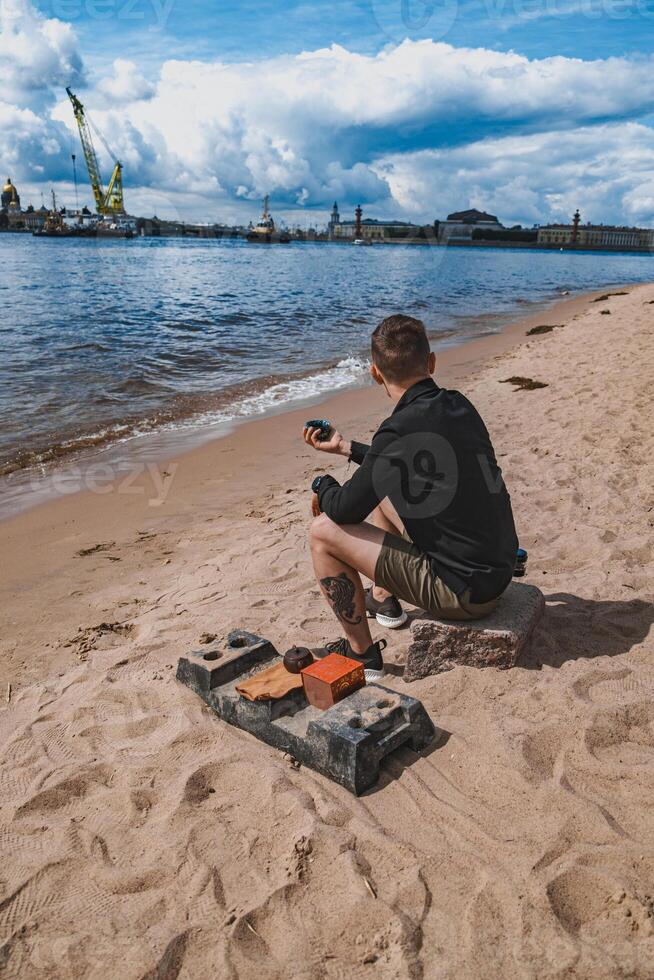 A man relaxes by the riverside, enjoying a peaceful moment and the beautiful view photo