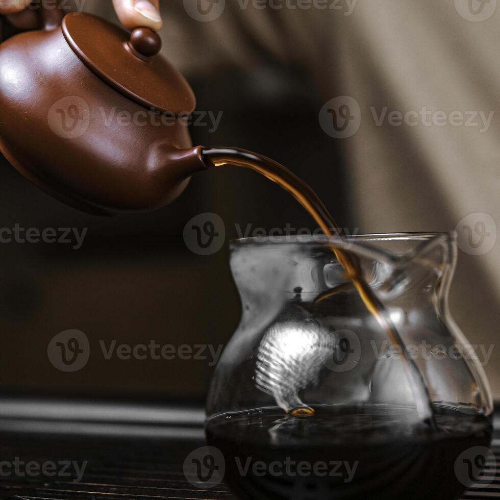 Elegant and refined tea brewing experience with a unique teapot and exquisite glass vessel photo