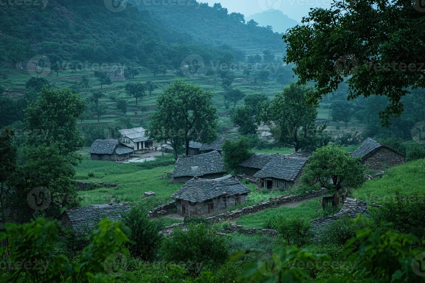Misty mountain village with traditional houses and lush green fields. photo
