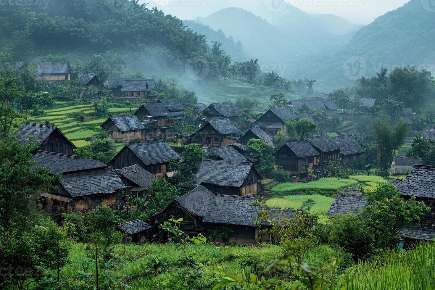 Misty mountain village with traditional houses and rice terraces. photo