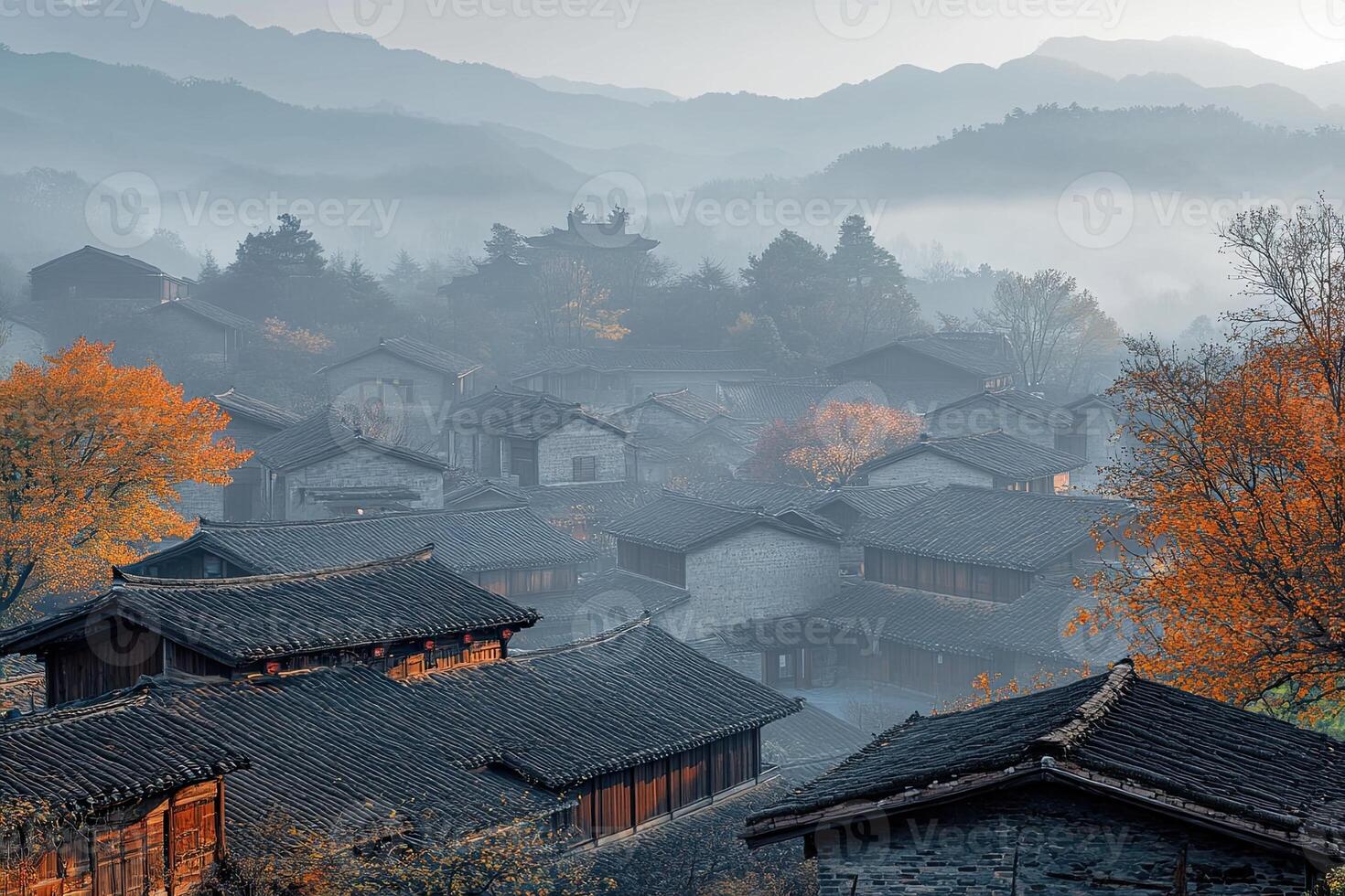 Misty mountain village at sunrise, autumn foliage. photo