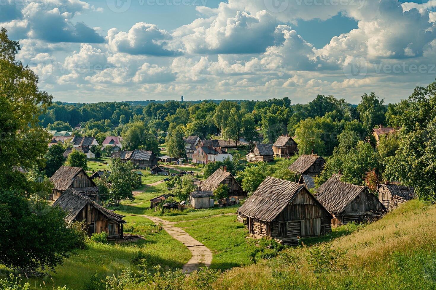 Picturesque rural village nestled in a verdant valley under a partly cloudy sky. photo