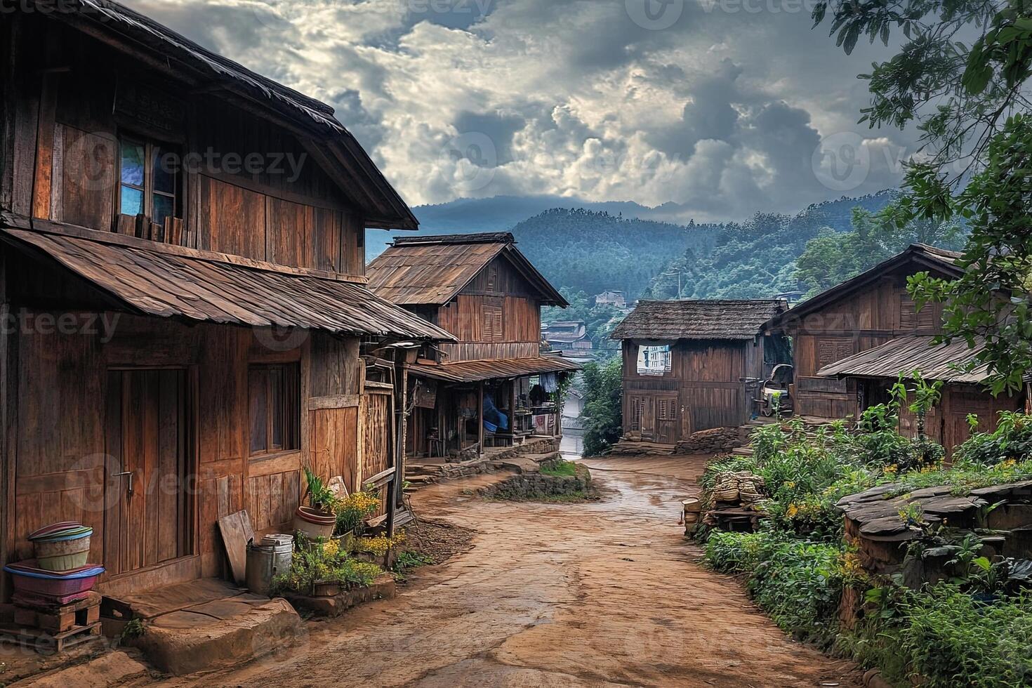 Rustic wooden houses line a dirt road in a mountainous village. photo