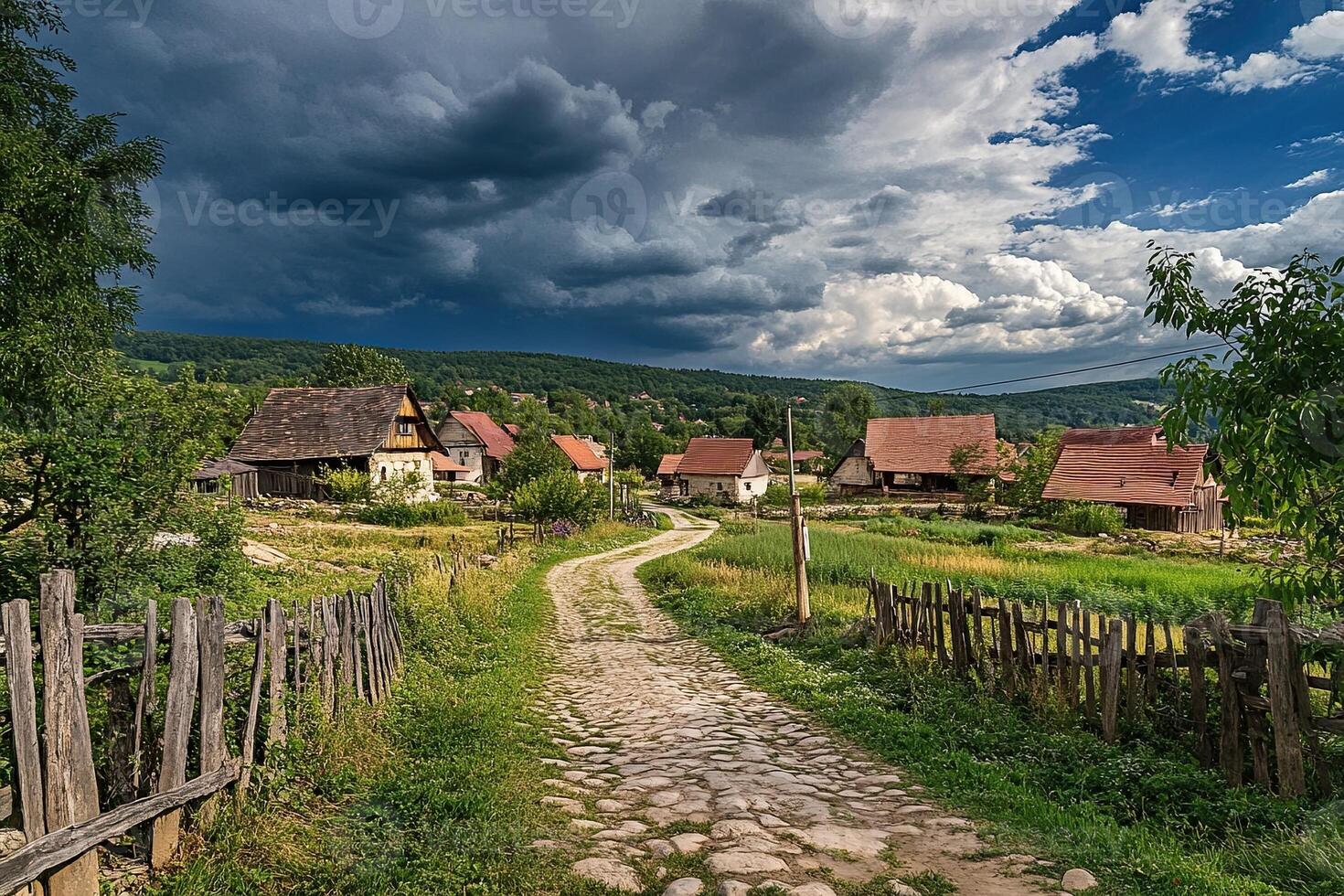Scenic village road with stone path, traditional houses, and dramatic sky. photo