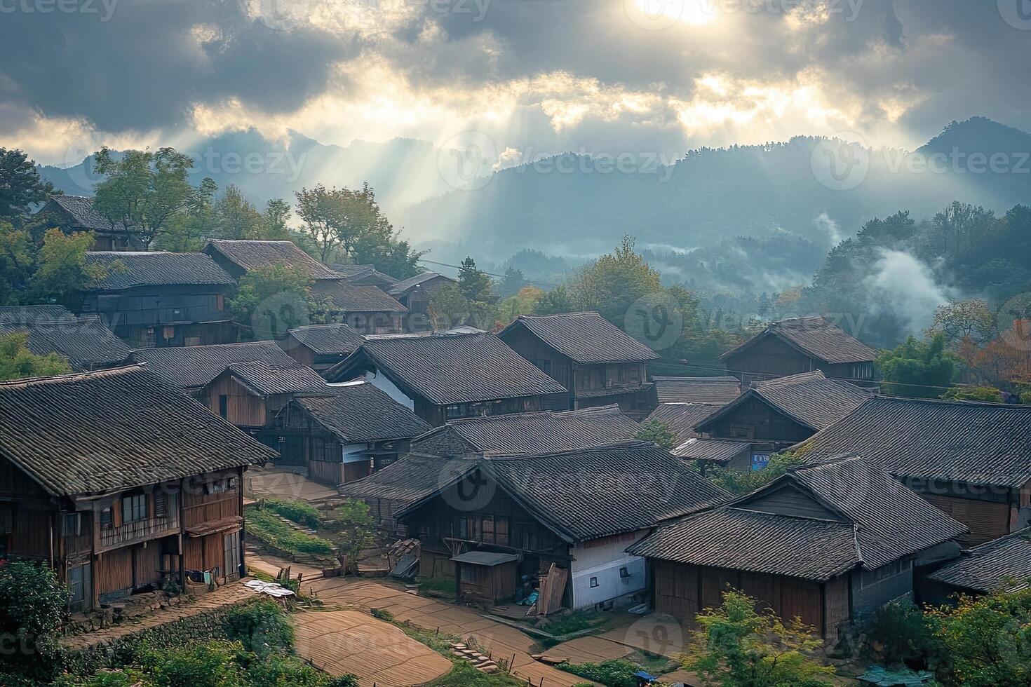 Sunbeams illuminate a mountain village with traditional houses. photo