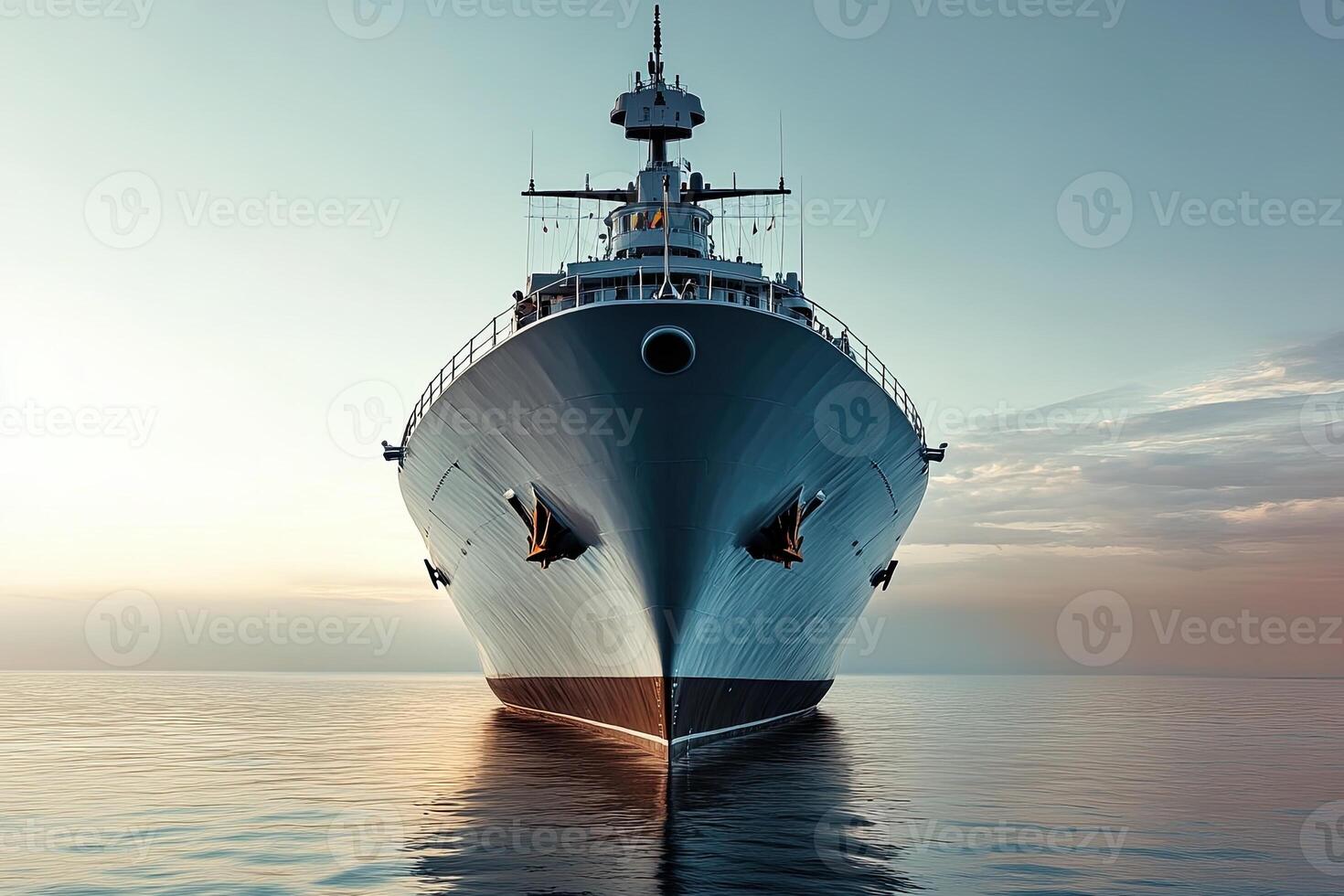 A large ship anchored in calm waters at sunset. photo