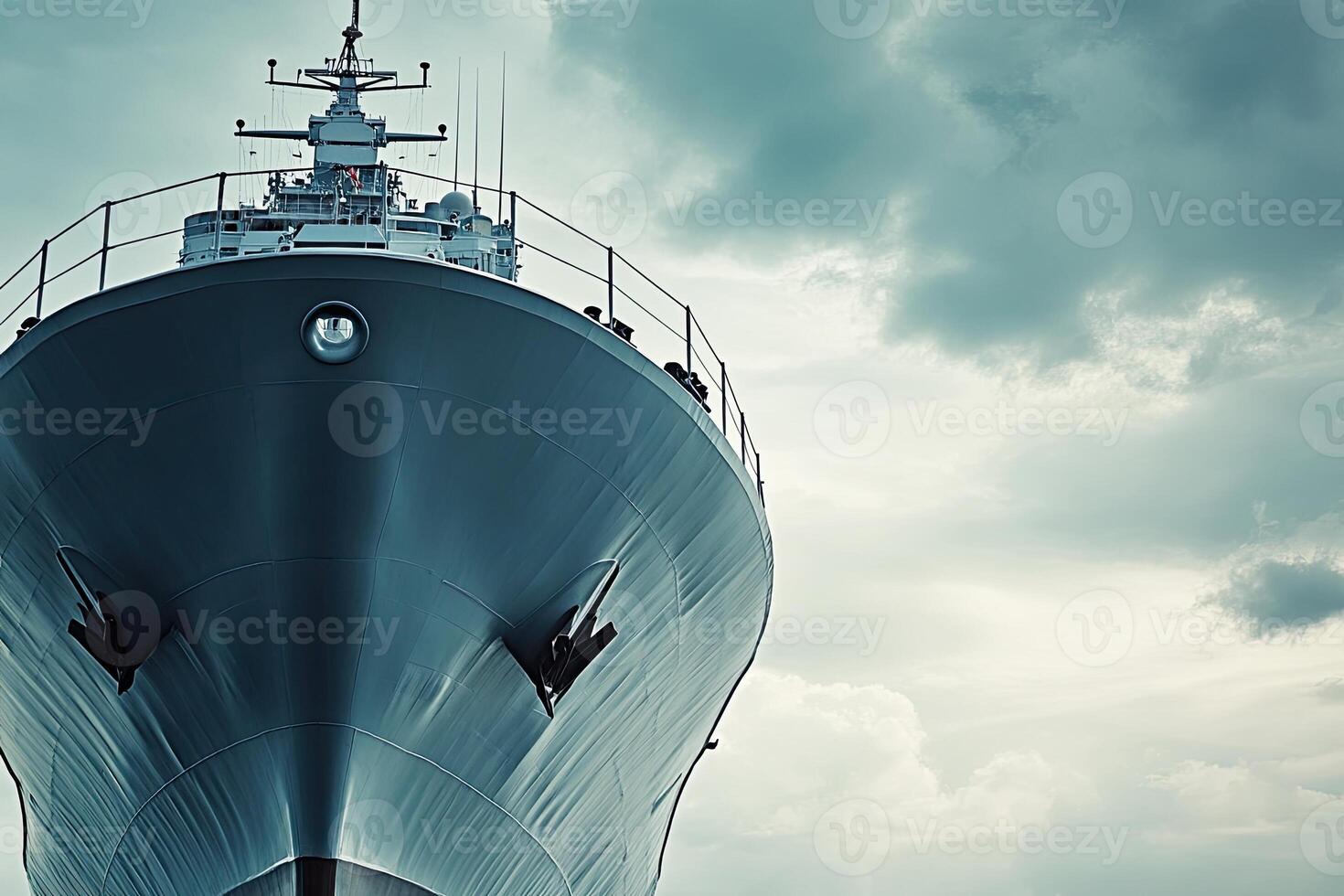 A close-up view of a ship's bow against cloudy skies. photo