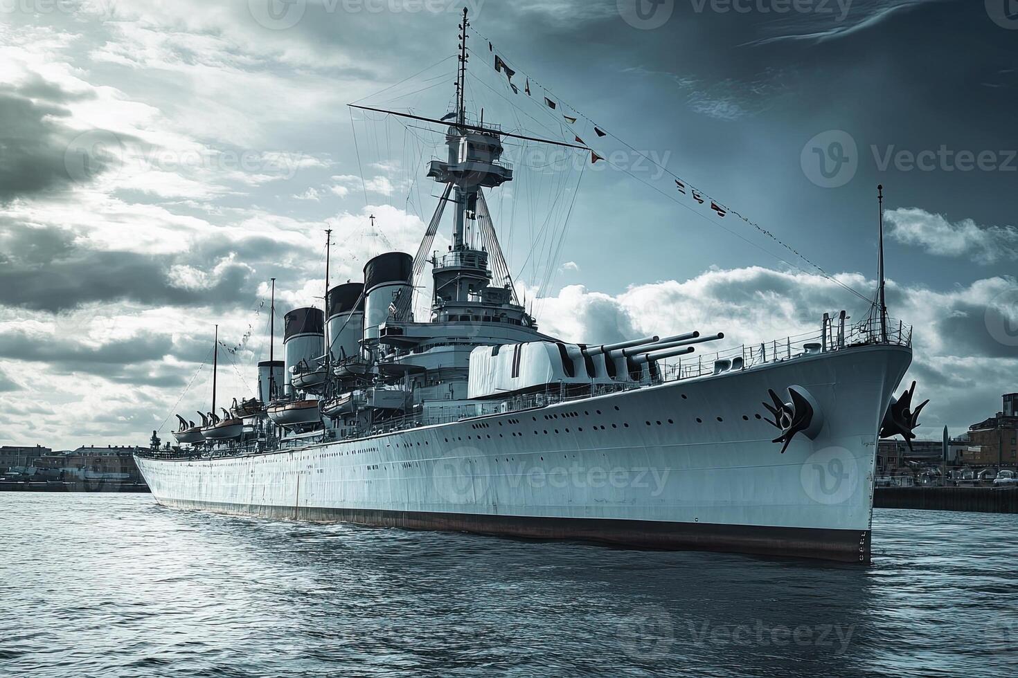 A battleship moored in water under a cloudy sky. photo
