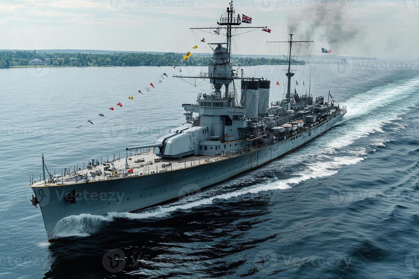 A battleship sailing on calm waters, displaying flags. photo
