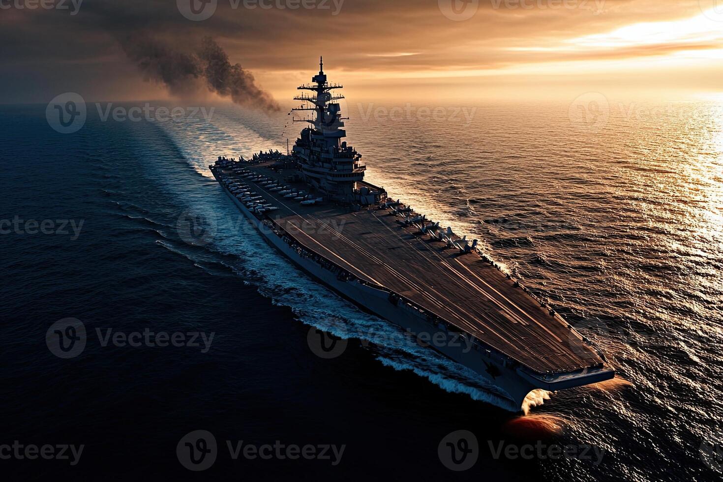 A battleship sailing through the ocean at sunset. photo