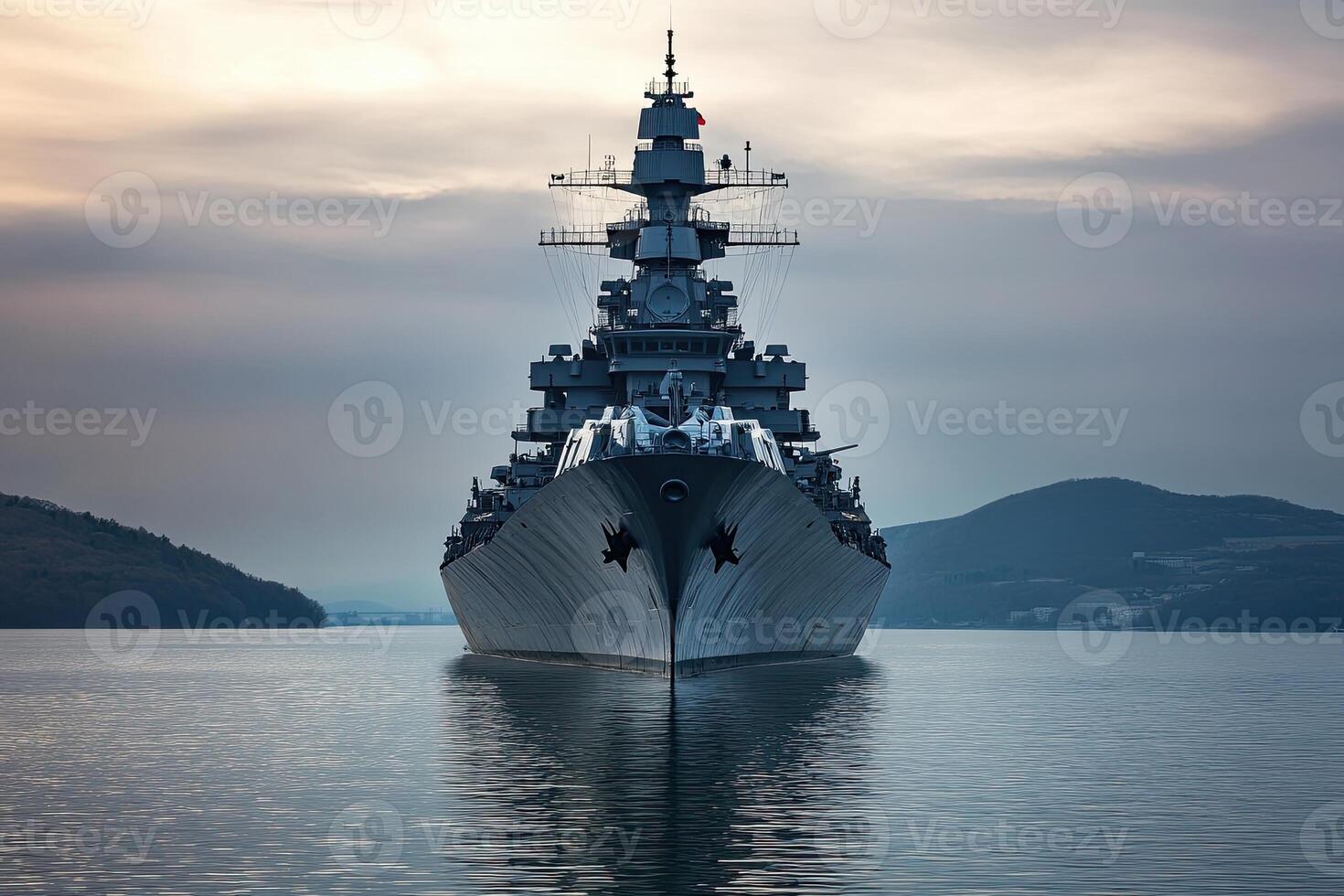 A battleship navigating calm waters at dusk. photo