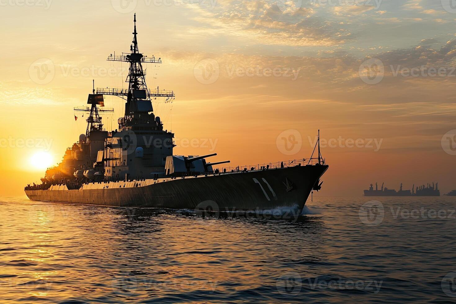 A battleship at sunset on calm waters. photo
