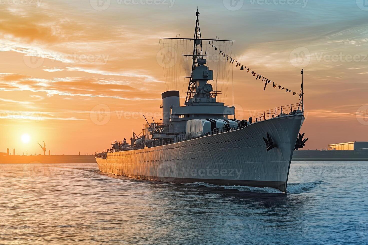 A historic warship sailing at sunset. photo
