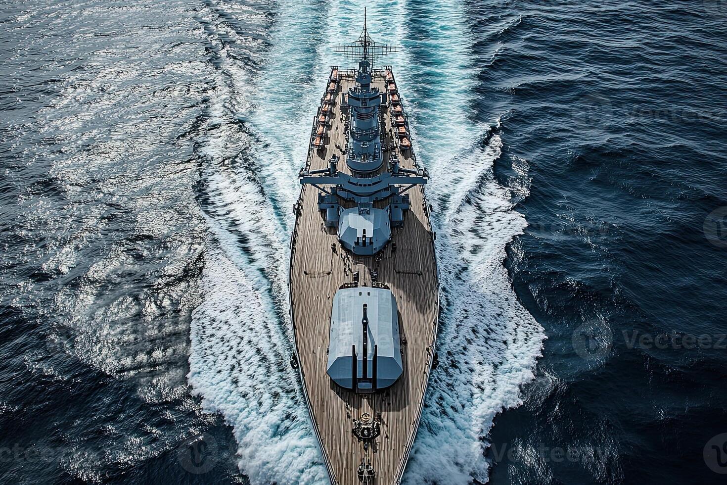 Aerial view of a naval ship navigating through ocean waves. photo