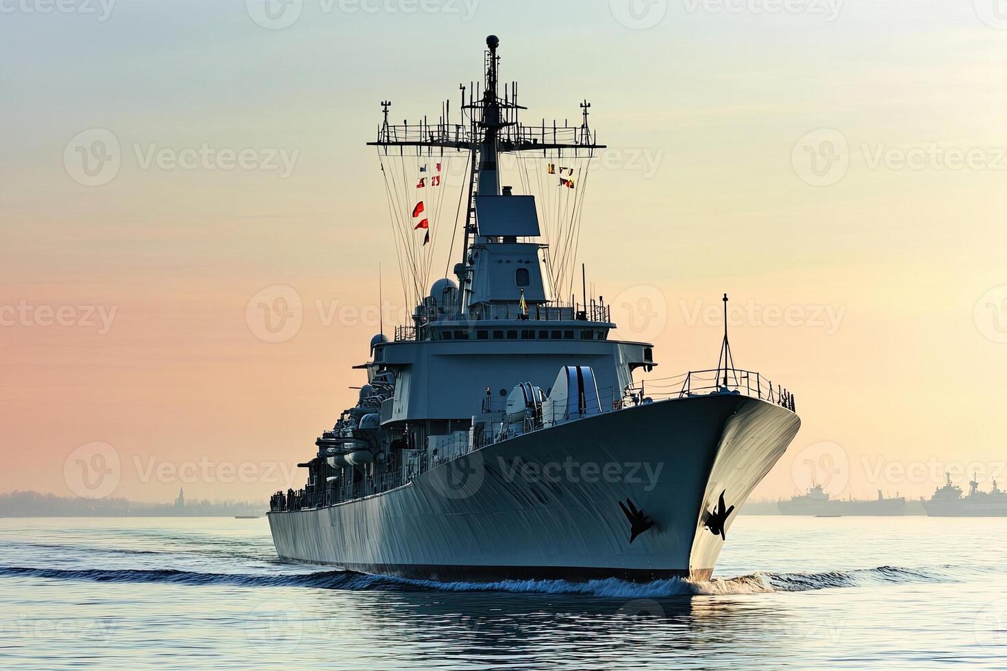 Naval ship navigating through calm waters at sunrise. photo