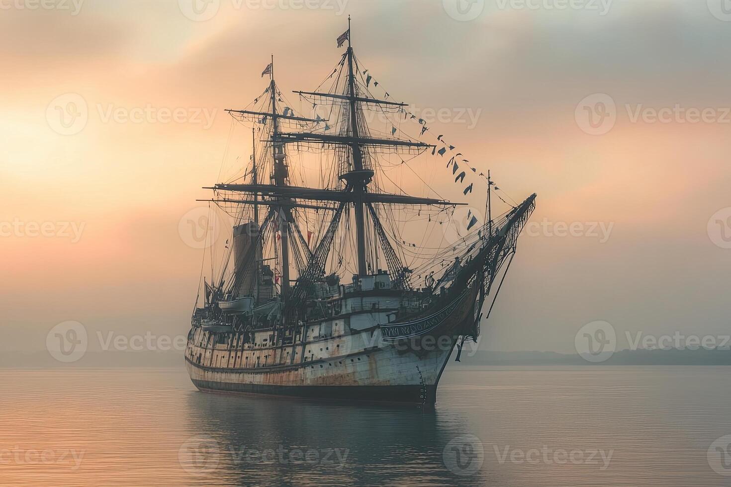 Old ship at sunset with a tranquil water reflection. photo