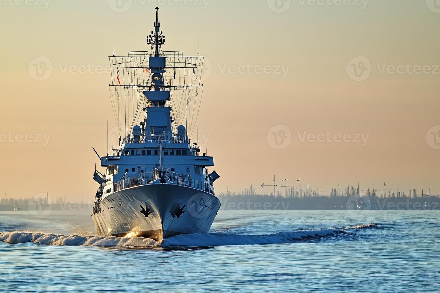 Naval ship navigating through calm waters at sunset. photo