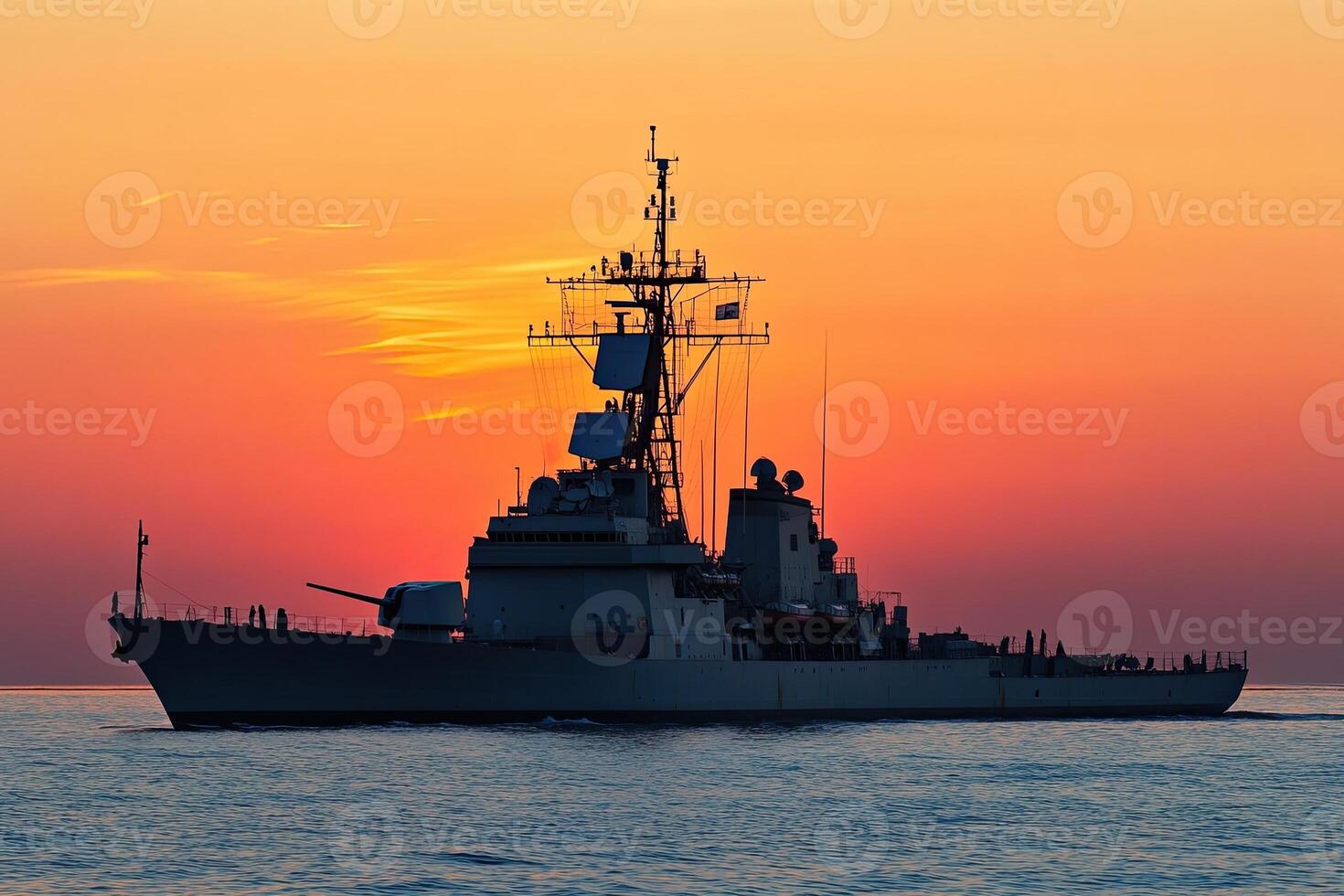 Warship silhouette against a vibrant sunset backdrop. photo