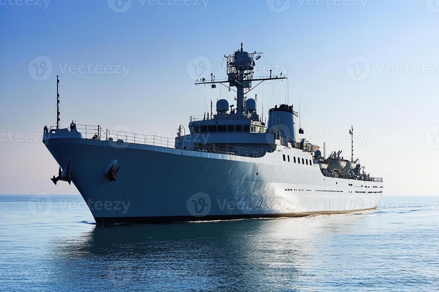 Naval ship navigating calm waters under clear skies. photo