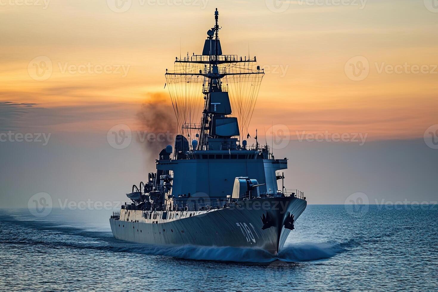 Naval ship navigating through water at sunset. photo
