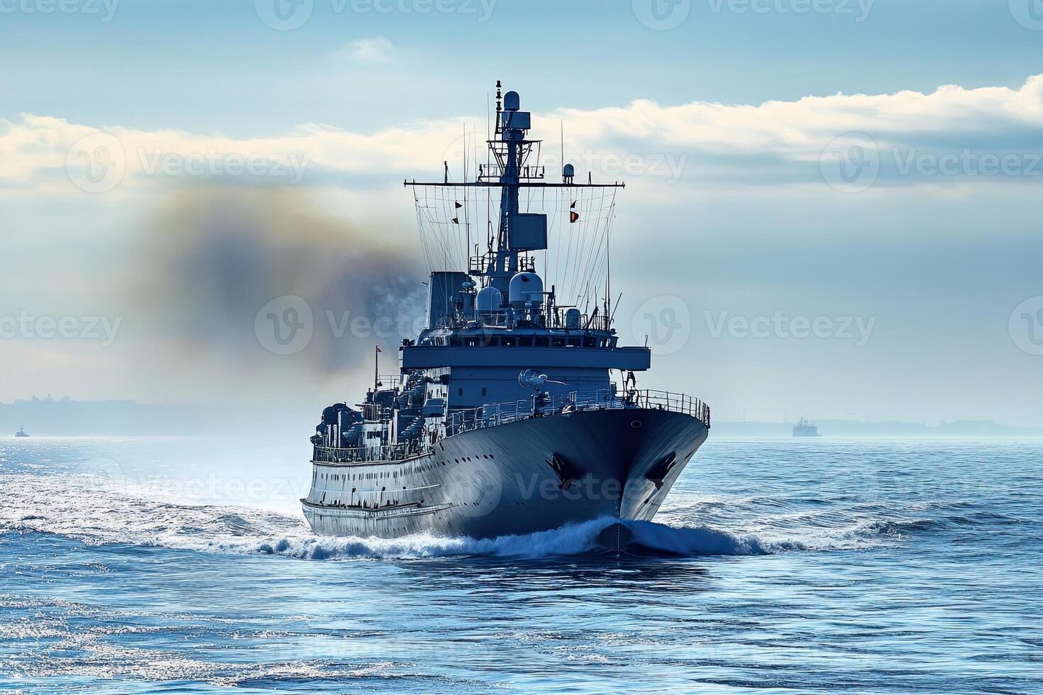 Naval ship navigating through calm waters with smoke. photo